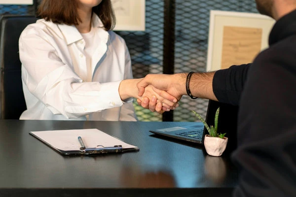 A licensed broker shaking hands with a client